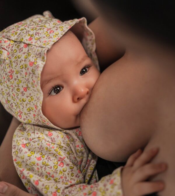 A mother smiling down at her infant.